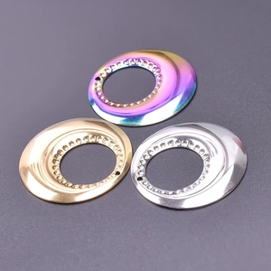 Macro shot of 18k gold, silver, and rainbow stainless steel circular DIY jewelry connectors