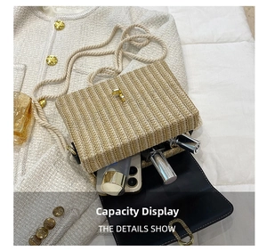 Detail view of woven straw crossbody bag interior showing phone and lipstick storage