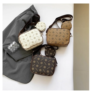 Detailed trio of monogram camera bags in white, khaki, and dark brown with round pouches