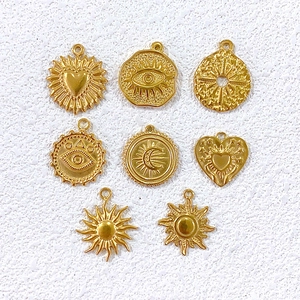 Eight golden stainless steel punk charms including heart sun moon and evil eye for DIY jewelry