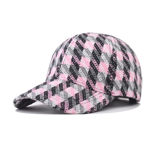 Close-up of pink and grey plaid baseball cap showing thick textured twill fabric detail