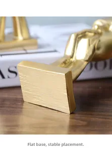Detail of stable matte gold rectangular base on modern minimalist resin sculpture