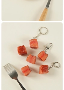 Detailed view of realistic artificial beef cubes and creative keychain pendants on a table