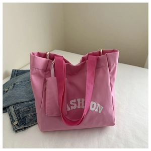 Pink printed tote bag with matching zipper pouch and white fashion slogan
