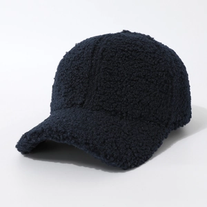 Detail of navy blue fuzzy teddy fleece texture on a warm winter baseball cap