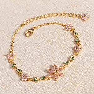 Detail of gold flower bracelet with pink zircon petals and adjustable lobster clasp