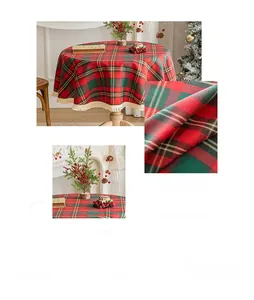 Close-up of red and green plaid Christmas tablecloth with white fringe tassels
