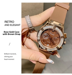 Detail of rose gold watch with crystal bezel and brown textured strap on wrist