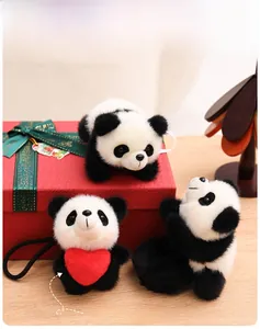 Detail of plush panda charm with red heart feature on a festive gift box