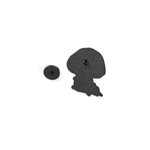 Macro view of the enamel pin back with black rubber clutch and textured metal base