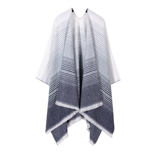 Close-up of knit shawl fringe detail with black and white gradient striped pattern