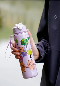 Detail of 750ml purple cartoon water cup featuring secure flip lid and portable lanyard