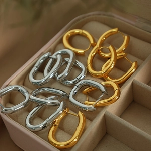 Minimalist U-shaped titanium steel hoop earrings in polished gold and silver finishes