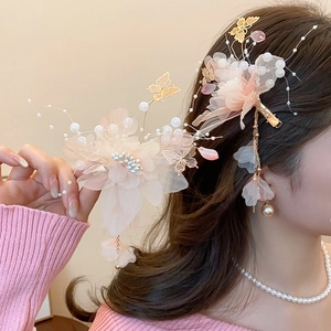 Detail of pink mesh flower hair clips with gold butterflies and elegant pearls