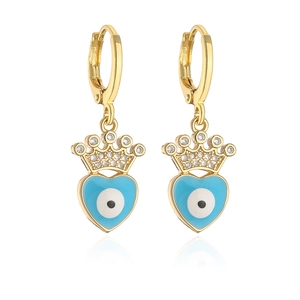 Detail of gold-plated heart earrings with blue evil eye zircon and crown accents