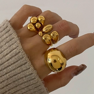 Exaggerated golden stainless steel ring set with spherical and pebble-shaped chunky designs