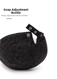 Close-up of the metal snap fastener on dark grey tweed newsboy cap for adjustable fit