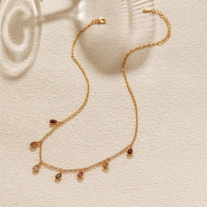 Detailed view of 18K gold-plated chain with multi-color teardrop zircon charms