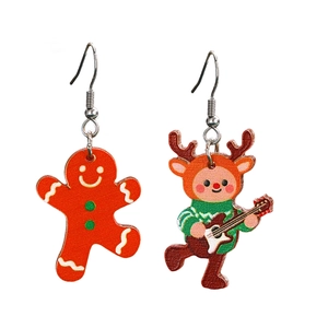 Detail of Christmas earrings featuring gingerbread man and reindeer with guitar