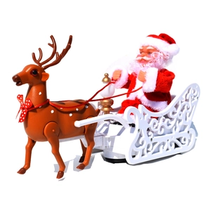 Detail of electric Santa Claus on white sleigh with reindeer Christmas tabletop decoration