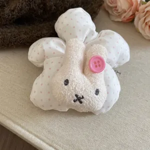 Cute bunny plush hair scrunchie with pink polka dots and soft white floral design