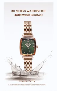 Detail of square green face watch with rose gold strap splashing in water for 3ATM waterproof