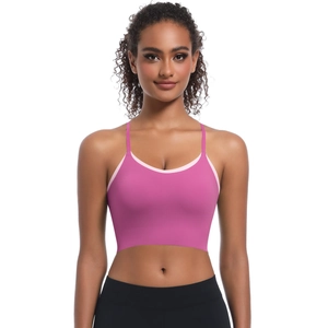 Detail of rose pink cross-back sports bra with light pink trim and thin straps