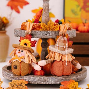 Harvest season gnome dolls with sunflower and pumpkin details on a wooden tray