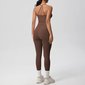 Detail of cross-back yoga top and high-waisted leggings in matte dark cocoa brown