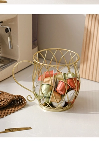 Golden wire coffee pod holder in mug shape on kitchen counter with coffee machine