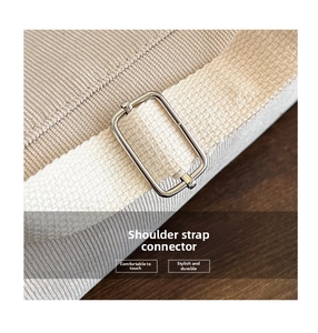 Detail of metal link and beige woven strap on corduroy shoulder bag with macro focus