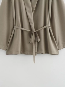 Detailed view of khaki blazer waist belt and premium fabric texture of the two-piece set