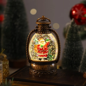 Close-up of golden Christmas lantern featuring a Santa Claus and tree snow globe scene