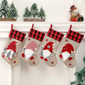 Set of four linen Christmas stockings with gnomes on white mantelpiece decorations