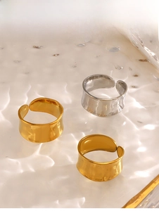 Macro shot of wide open rings with hammered texture in gold and silver finishes