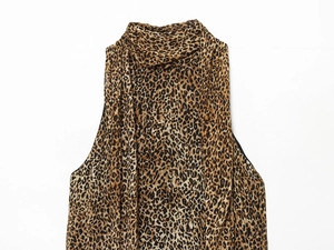 Detail of leopard print halter neck sleeveless dress featuring lightweight chiffon texture