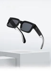 Detail of square sunglasses with black glossy frames and textured silver metal temples