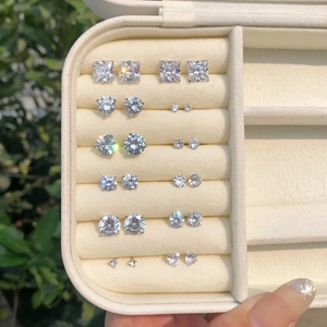 Macro view of seven pairs of S925 sterling silver studs with various zircon shapes in a box