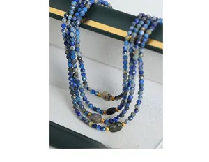 Detail of beaded lapis lazuli necklace with labradorite stones on a jewelry box