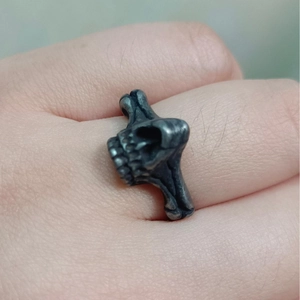 Gothic skull ring for men in vintage grey stainless steel on hand portrait shot