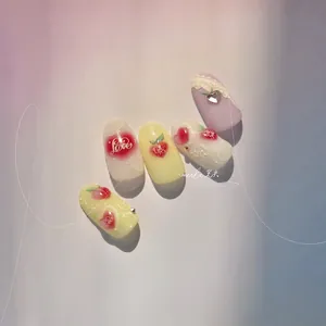 Detail of sweet heart nail art press-on tips with 3D pearls and peach painting