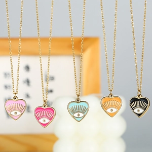 Macro detail of colorful enamel heart evil eye pendants with golden chains