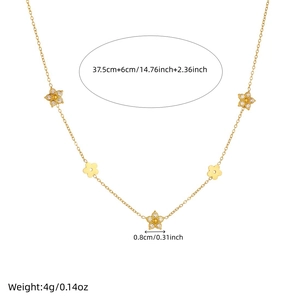 Gold plated stainless steel necklace featuring floral charms with inset crystals on white base
