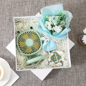 Gift box detail with green frog mini fan, soap flowers and lucky message package