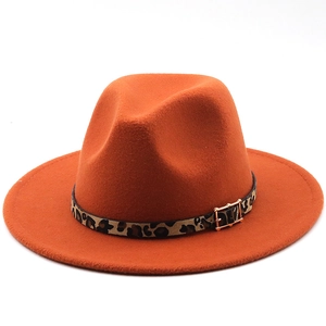 Close-up of orange wool fedora with leopard print band and gold buckle detail