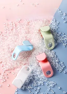 Macro shot of colorful plastic clothes hanger connector hooks on a textured background