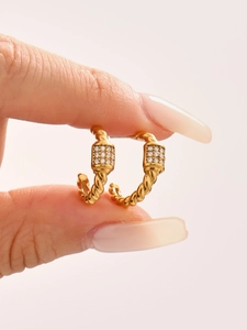 Detailed view of 18k gold plated twisted hoop earrings with micro pave 5A zircons