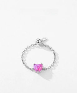 Detailed macro view of S925 sterling silver chain ring with pink heart opal and slider