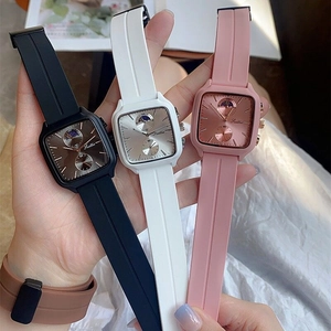 Three square silicone strap watches in black, white, and pink with moon phase dials