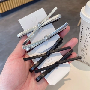 Set of 4 minimalist faux leather bow hair clips in sleek black and metallic silver finishes